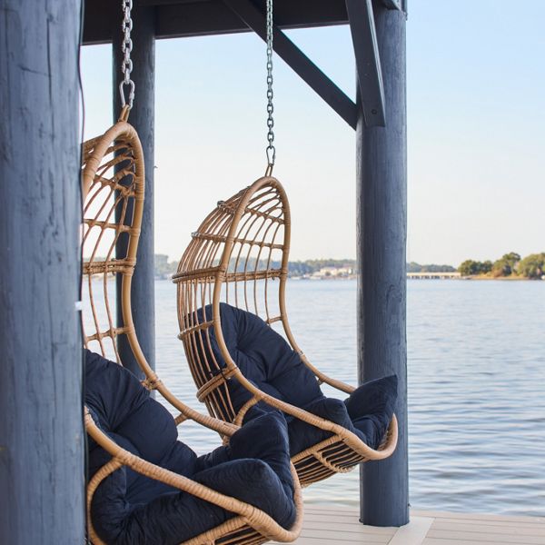 Two swinging chairs on a Salt Flat deck overlooking the water.